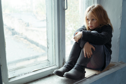 Like a shag on a rock. Poor depressed hopeless girl folding her legs and sitting on the window sill while feeling unhappy